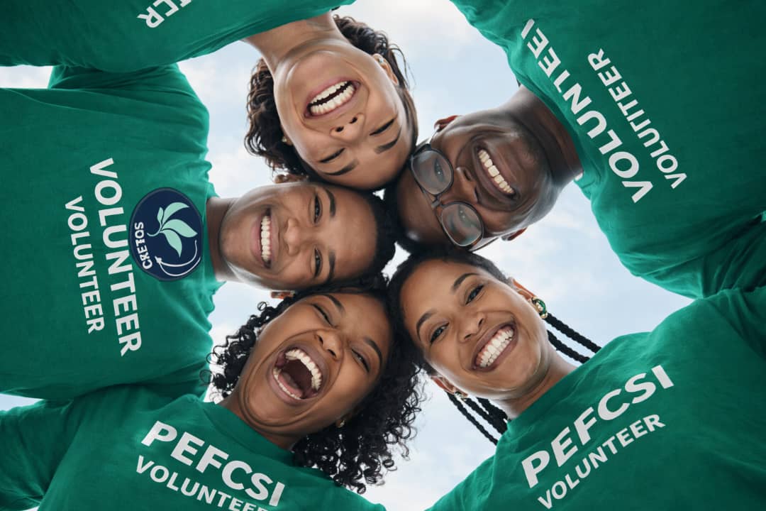 Smiling volunteers in PEFCSI shirts